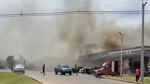 This frame grab from UGC video footage taken and posted on Facebook by Chatchak Ratsamikaeo on July 24, 2025 shows smoke billowing from the roof of a convenience store attached to a petrol station in Sisaket province after it was hit by a rocket strike from Cambodia. Thailand launched air strikes on Cambodian military targets on July 24 as Cambodia fired rockets and artillery, killing at least 11 civilians, in a dramatic escalation of a long-running border row between the two neighbours. (Photo by Courtesy of Facebook user Chatchak Ratsamikaeo / AFP) / -----EDITORS NOTE --- RESTRICTED TO EDITORIAL USE - MANDATORY CREDIT AFP PHOTO /Courtesy of Facebook user Chatchak Ratsamikaeo   - NO MARKETING - NO ADVERTISING CAMPAIGNS - DISTRIBUTED AS A SERVICE TO CLIENTS - NO ARCHIVES