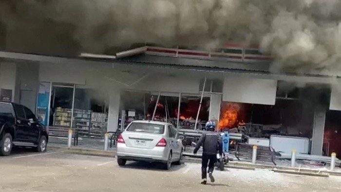Smoke and fire rise from a convenience store at a gas station, amid the clashes between Thailand and Cambodia, in Kantharalak district, Sisaket province, Thailand, July 24, 2025, in this screengrab obtained from a handout video. Army Region 2 via Facebook/Handout via REUTERS    THIS IMAGE HAS BEEN SUPPLIED BY A THIRD PARTY. NO RESALES. NO ARCHIVES. MANDATORY CREDIT.  VERIFICATION LINES - Reuters was able to verify the location from the sign, road layout and buildings which matched file and satellite imagery of the area.  - Reuters was able to confirm the date from local reports on the ground.