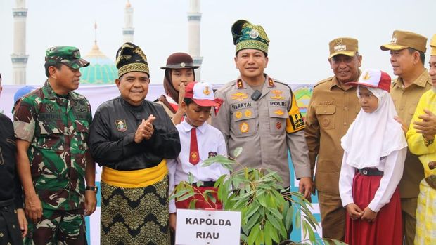 Kapolda Riau Irjen Herry Heryawan melakukan penanaman pohon bersama anak-anak SD di Rokan Hulu, Jumat (25/7/2025).