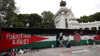 Orang-orang melukis saat berpartisipasi dalam acara yang diselenggarakan oleh brigade muralis untuk mendukung rakyat Palestina. Pasukan Israel telah menewaskan hampir 60.000 warga Palestina dalam serangan udara, penembakan, dan penembakan sejak melancarkan serangan mereka di Gaza sebagai tanggapan atas serangan terhadap Israel oleh kelompok Hamas yang menewaskan 1.200 orang dan menyandera 251 orang pada Oktober 2023. Foto: REUTERS/Luis Cortes