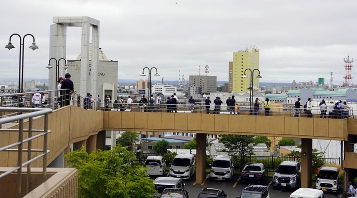 People look on after being evacuated to a temporary tsunami evacuation site, after Japan issued evacuation alert following major quake in Russias Kamchatka Peninsula that triggered a tsunami warning, in Kushiro, Hokkaido, Japan July 30, 2025, in this photo taken by Kyodo. Kyodo/via REUTERS ATTENTION EDITORS - THIS IMAGE HAS BEEN SUPPLIED BY A THIRD PARTY. MANDATORY CREDIT. JAPAN OUT. NO COMMERCIAL OR EDITORIAL SALES IN JAPAN.