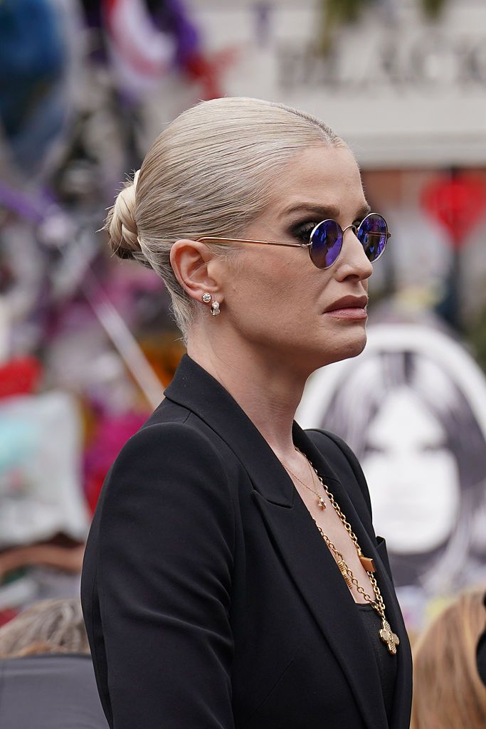 Kelly Osbourne views the messages and floral tributes left at the Black Sabbath Bridge bench on Broad Street in Birmingham in memory of her father, Black Sabbath frontman Ozzy Osbourne, as his body is brought back to his home city for a procession following his death last week aged 76. Picture date: Wednesday July 30, 2025. Photo credit should read: Joe Giddens/PA Wire (Photo by Joe Giddens/PA Images via Getty Images)