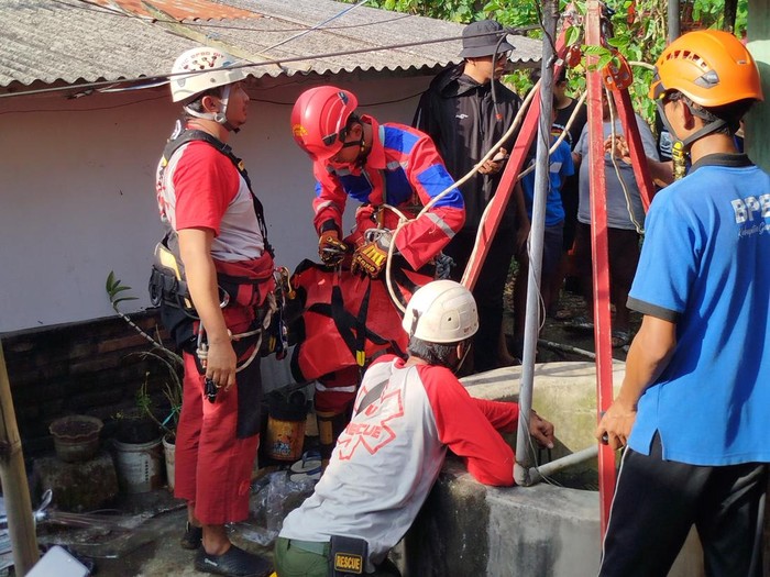 Petugas mengevakuasi seorang pemuda tercebur ke dalam sumur di Logandeng, Playen, Gunungkidul, Jumat (1/8/2025).