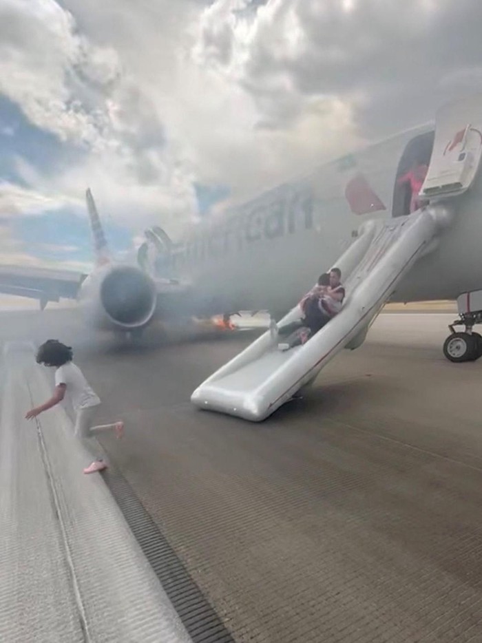 Passengers evacuate an American Airlines plane by an emergency slide as a fire burns and smoke emits from the aircraft, at the Denver International Airport, Denver, Colorado, U.S. July 26, 2025, in this screengrab obtained from a social media video. @highlymigratoryfishing via Instagram/via REUTERS  THIS IMAGE HAS BEEN SUPPLIED BY A THIRD PARTY. MANDATORY CREDIT. NO RESALES. NO ARCHIVES.  VERIFICATION LINES -  Location was verified by the runway outline that matched the one from the Denver International Airport satellite imagery. The date when the videos were filmed was verified by original file metadata.