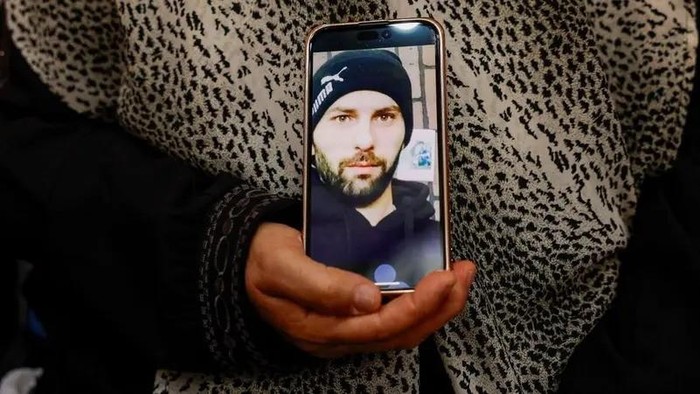 Haleema Ayyad holds a photo of her son, Khamis Ayyad, after he was killed in an attack by Israeli settlers in Silwad village near Ramallah, in the Israeli-occupied West Bank, July 31, 2025. (Reuters)