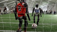 T1 humanoid robots developed by Booster Robotics in action on a football pitch, during a practice in preparation for soccer competitions at the inaugural World Humanoid Robot Games, at the National Speed Skating Oval in Beijing, China August 1, 2025. REUTERS/Florence Lo