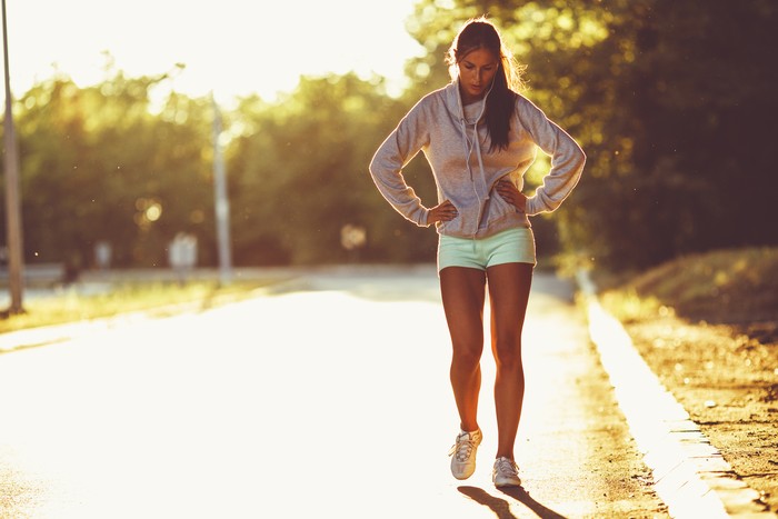 Tired female runner walking.She is exhausted of running.