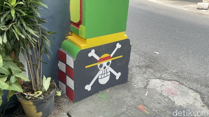 Dekorasi mural Jolly Roger dari anime One Piece di Surabaya.