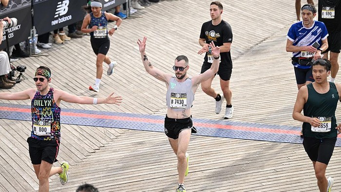 NEW YORK, NEW YORK - MAY 17: Runners cross the finish line during the RBC Brooklyn Half Marathon on May 17, 2025 in New York City. The RBC Brooklyn Half is held in Brooklyn, NY and finishes on the boardwalk at Coney Island. (Photo by Bryan Bedder/New York Road Runners via Getty Images)