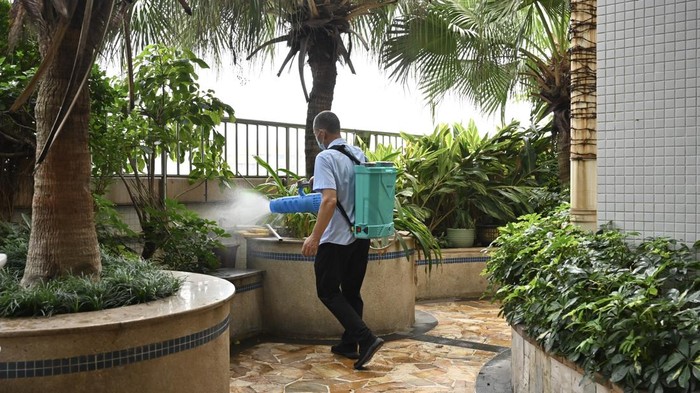 GUANGZHOU, CHINA - JULY 30: A staff member carries out mosquito eradication work on a rooftop sewer on July 30, 2025 in Guangzhou, Guangdong Province of China. China's Guangdong Province has launched targeted measures, including citywide cleanup efforts, to effectively curb the spread of Chikungunya fever, a mosquito-borne viral disease. (Photo by Chen Chuhong/China News Service/VCG via Getty Images)
