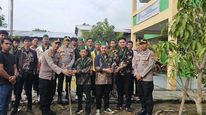 Polisi dan mahasiswa HMI melakukan aksi nyata mendukung Green Policing tanam pohon di Kota Dumai, Minggu (10/8/2025).