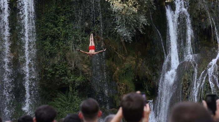 Lomba Loncat Air Terjun Bosnia Tarik Wisatawan Dunia A drone view shows competitors taking part in the annual international waterfall jumping competition held in the old town of Jajce, Bosnia and Herzegovina, August 9, 2025. REUTERS/Amel Emric TPX IMAGES OF THE DAY