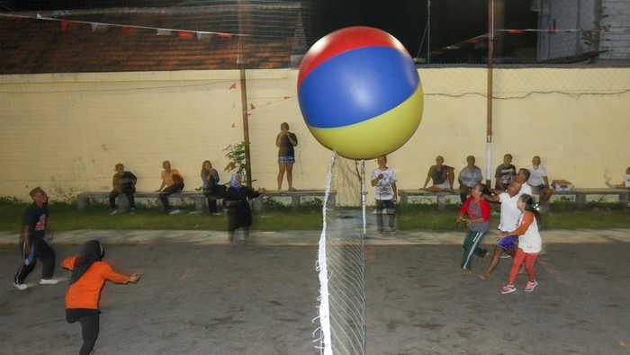 Warga melemparkan bola raksasa ke area lawan pada perlombaan Agustusan di Banyuwangi, Jawa Timur, Selasa (12/8/2025). Lomba digelar untuk memeriahkan Hari Kemerdekaan Republik Indonesia sekaligus meningkatkan kekompakan dan semangat kebersamaan antarwarga. ANTARA FOTO/Budi Candra Setya/rwa.
