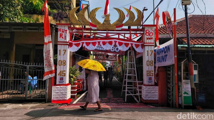 Sejumlah warga beraktivitas diantara pernak pernik HUT ke-80 Republik Indonesia di kawasan permukiman padat Tanjung Priok, Jakarta Utara, Rabu (13/8/2025).