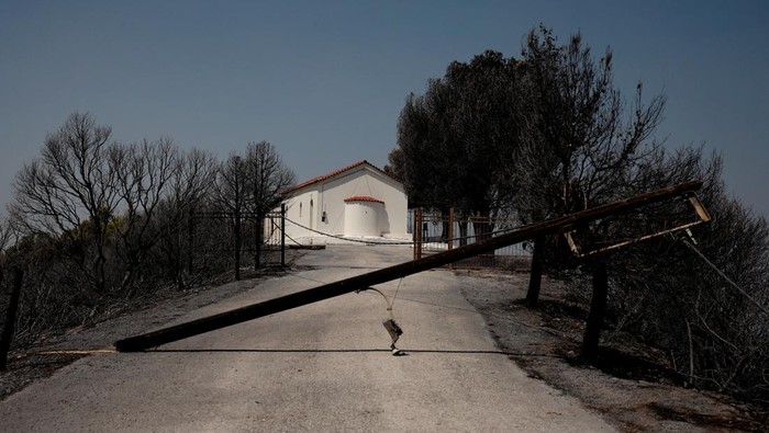 A drone view of a church amidst a burnt area following a wildfire in Kaminia, near Patras, Greece, August 13, 2025. REUTERS/Louiza Vradi
