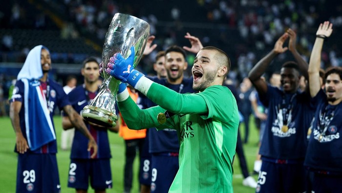 Soccer Football - UEFA Super Cup - Final - Paris St Germain v Tottenham Hotspur - Bluenergy Stadium, Udine, Italy - August 13, 2025 Paris Saint Germains Lucas Chevalier celebrates with the trophy after winning the UEFA Super Cup REUTERS/Guglielmo Mangiapane