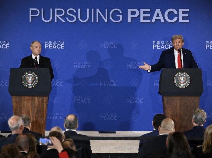 US President Donald Trump (R) gestures toward Russian President Vladimir Putin as they deliver a joint press conference after participating in a US-Russia summit on Ukraine at Joint Base Elmendorf-Richardson in Anchorage, Alaska, on August 15, 2025. (Photo by Drew ANGERER / AFP)