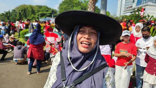 Antusiasme warga nonton upacara HUT ke-80 RI dari layar besar di depan Istana Merdeka, Jakarta