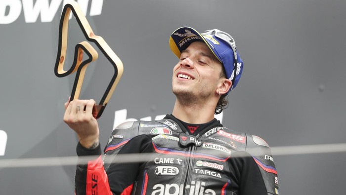 SPIELBERG, AUSTRIA - AUGUST 17: Marco Bezzecchi of Italy riding the Aprilia Racing bike (72) celebrates on the podium after finishing third during the MotoGP of Austria race at Red Bull Ring on August 17, 2025 in Spielberg, Austria. (Photo by Gold & Goose Photography/Getty Images)