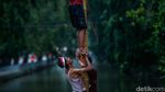 Jatuh Bangun, Peserta Akhirnya Taklukkan Pinang di Tengah Sungai Bekasi