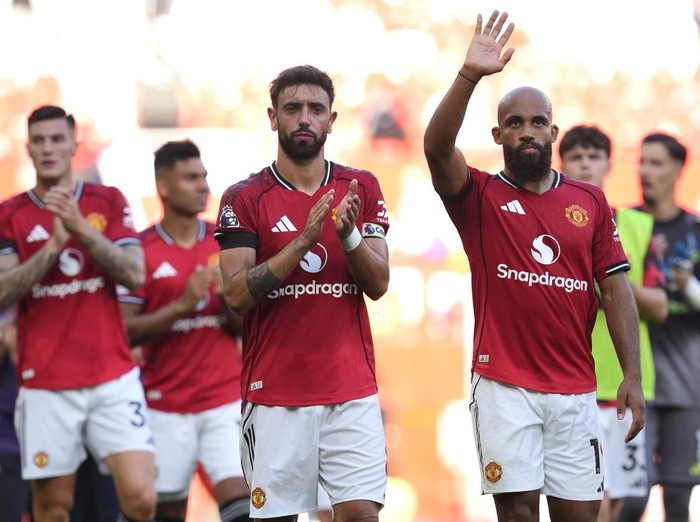 Manchester United's Bruno Fernandes and Bryan Mbeumo (right) applaud the fans after the final whistle following defeat in the Premier League match at Old Trafford, Manchester. Picture date: Sunday August 17, 2025. (Photo by Nick Potts/PA Images via Getty Images)