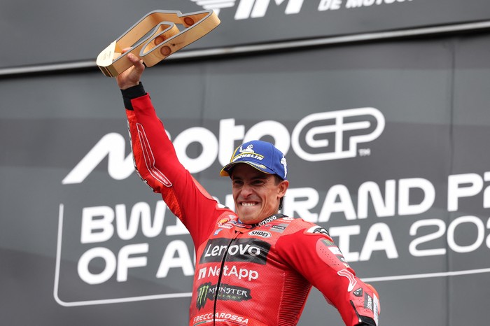 MotoGP - Austrian Grand Prix - Red Bull Ring, Spielberg, Austria - August 17, 2025 Ducati Lenovo Teams Marc Marquez celebrates with a trophy on the podium after winning the Austrian MotoGP REUTERS/Gintare Karpaviciute
