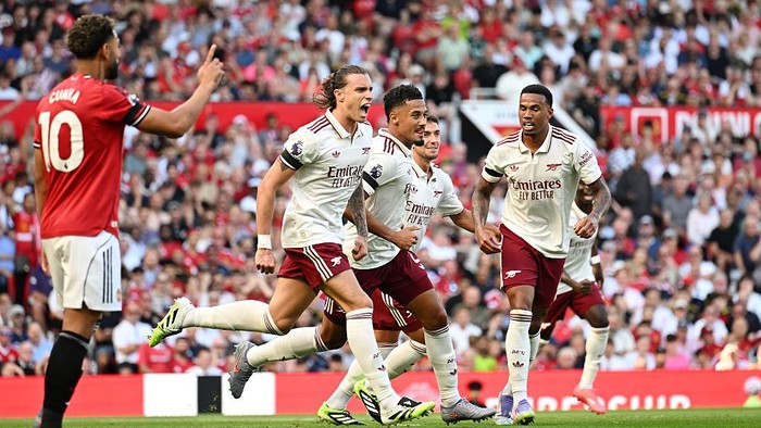 MANCHESTER, ENGLAND - AUGUST 17: Riccardo Calafiori of Arsenal celebrates scoring his teams first goal with William Saliba and Gabriel of Arsenal during the Premier League match between Manchester United and Arsenal at Old Trafford on August 17, 2025 in Manchester, England. (Photo by Stuart MacFarlane/Arsenal FC via Getty Images)