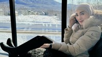 Erin Taulany menulis di bio Instagram soal dia suka fashion. Ini penampilannya berjaket tebal dan celana hitam panjang dengan latar gunung. (Foto: dok Instagram erintaulany)