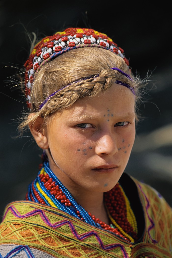 A young blond Kalash girl who lives in the Bumburet Valley. The Kalash have resisted outsiders for generations, and are some of the only non-Muslims in the area. | Location: Near Chitral, Pakistan.