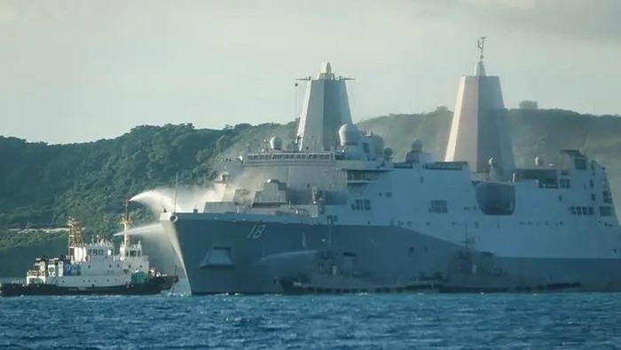 This handout photo taken on August 20, 2025 shows smoke coming from the US Navy vessel USS New Orleans as water is sprayed (L) to help put out the fire. (AFP)