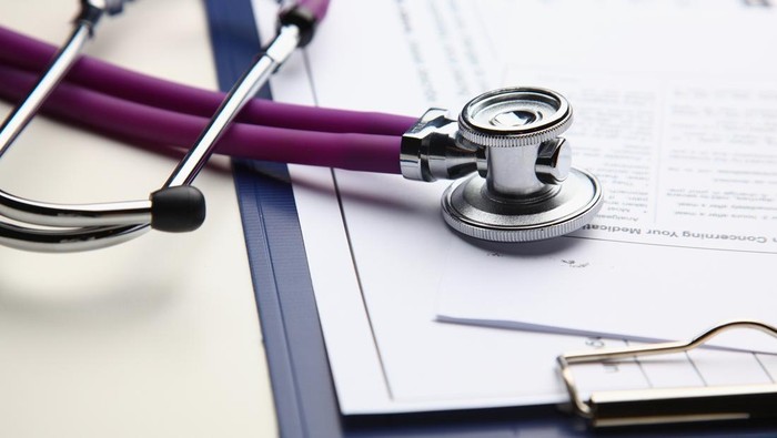 Closeup of a medical stethoscope with folder .