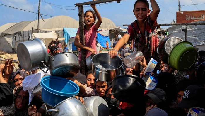 PBB Resmi Nyatakan Gaza Alami Bencana Kelaparan FILE PHOTO: Palestinians wait to receive food from a charity kitchen, in Khan Younis, southern Gaza Strip, August 21, 2025. REUTERS/Hatem Khaled/File Photo