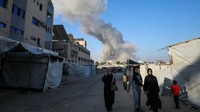 Warga Palestina terlihat berjalan di tengah debu dan asap tebal yang menutupi jalan-jalan utama kota, menciptakan pemandangan dramatis dan penuh kecemasan. REUTERS/Dawoud Abu Alkas