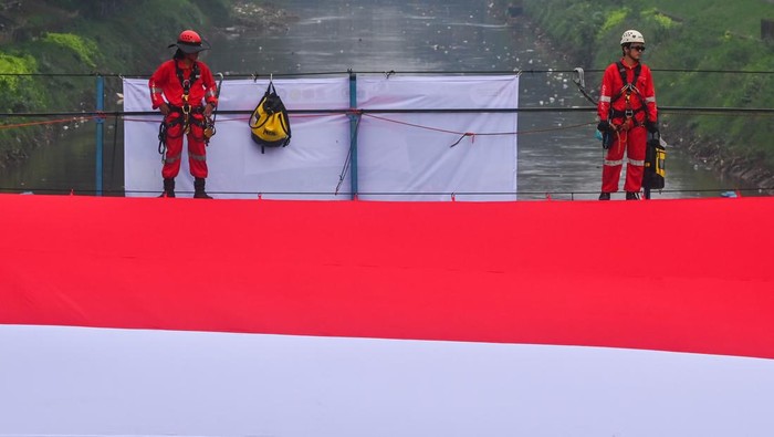 Merah Putih Raksasa Berkibar di Atas Banjir Kanal Barat Jakarta Petugas gabungan mengibarkan Bendera Merah Putih berukuran raksasa di Banjir Kanal Barat, Jakarta, Minggu (24/8/2025). Pengibaran bendera berukuran 17 x 8 meter tersebut dalam rangka memperingati HUT ke-80 Kemerdekaan RI. ANTARA FOTO/Rivan Awal Lingga