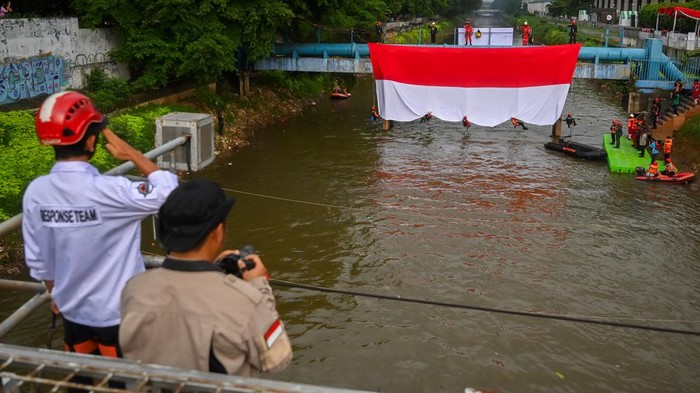 Merah Putih Raksasa Berkibar di Atas Banjir Kanal Barat Jakarta Petugas gabungan mengibarkan Bendera Merah Putih berukuran raksasa di Banjir Kanal Barat, Jakarta, Minggu (24/8/2025). Pengibaran bendera berukuran 17 x 8 meter tersebut dalam rangka memperingati HUT ke-80 Kemerdekaan RI. ANTARA FOTO/Rivan Awal Lingga