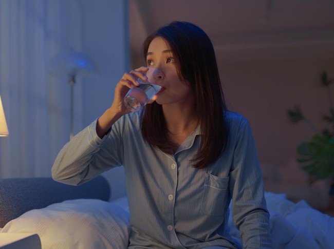 closeup asain woman take medicine before going to bed - she need to take sleeping pills