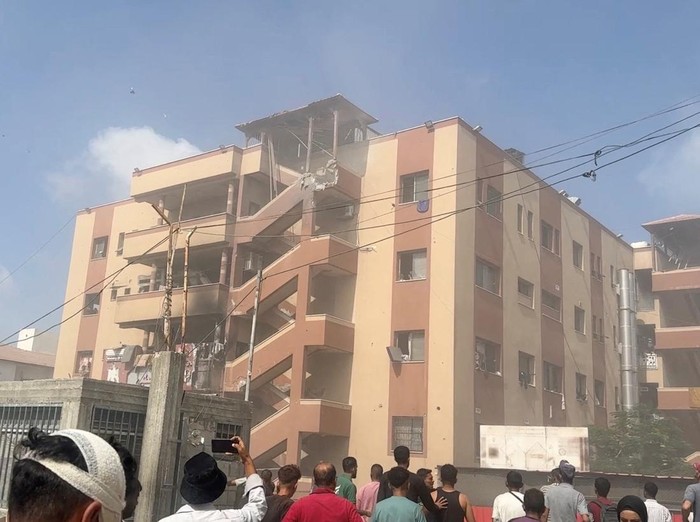 People walk at the site of Israeli strikes on Nasser hospital where Palestinian cameraman Hussam al-Masri, who was a contractor for Reuters, was killed along with other journalists and people, in Khan Younis in the southern Gaza Strip in this still image taken from video, August 25, 2025. REUTERS/Hatem Khaled