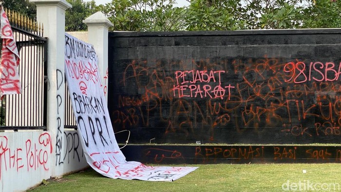 Sejumlah orang demonstrasi di gerbang belakang gedung MPR/DPR, Jakarta. Tembok gerbang belakang gedung MPR/DPR menjadi sasaran vandalisme. (Devi P/detikcom)