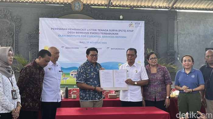 IESR menyerahkan berita acara pemasangan PLTS atap kepada Kepala Desa Banjarasem di Balai Desa Banjarasem, Buleleng, Rabu (27/8/2025). (Rizky Setyo)