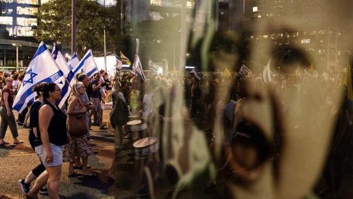 Protesters gather with flags during a demonstration organised by the families of the Israeli hostages taken captive in the Gaza Strip since the October 2023 attacks, calling for action to secure their release and a ceasefire in the war against Hamas, in Tel Aviv on August 26, 2025. Thousands of demonstrators massed in Tel Aviv on August 26 as the security cabinet convened. The security cabinet had in early August approved a plan for the military to take over Gaza City, triggering fresh fears for the safety of the hostages and a new wave of protests that has seen tens of thousands take to the streets. (Photo by JOHN WESSELS / AFP)