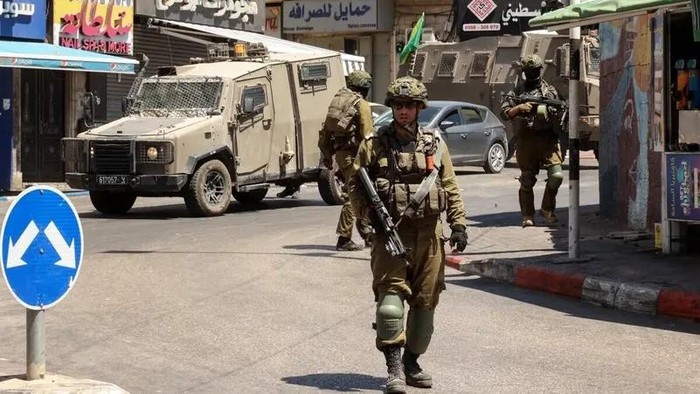 Israeli soldiers conduct a raid in Ramallah city in the occupied West Bank on August 26, 2025. (AFP)