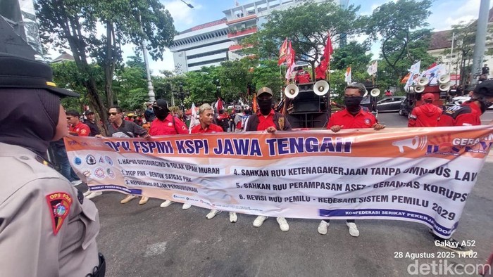 Personel Polda Jateng dan Polrestabes Semarang saat mengamankan aksi buruh di depan Kantor Gubernur Jateng di Jalan Pahlawan, Kota Semarang, Kamis (28/8/2025).