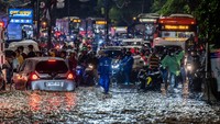 Kendaraan terhenti akibat luapan Kali Baru yang menutup sebagian ruas Jalan Raya Bogor dari arah Bogor menuju Jakarta. Foto: ANTARA FOTO/Bayu Pratama S
