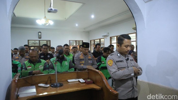 Driver ojol dan polisi melakukan salat gaib untuk Affan Kurniawan.