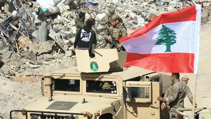 Lebanese army troops patrol the destroyed southern border village of Adaisseh, following the Israeli forces withdrawal on February 18, 2025. (AFP)