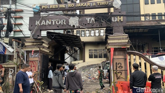 Polres Metro Jakarta Timur dilempar molotov tadi malam. Hal ini mengakibatkan beberapa mobil terbakar. Proses evakuasi berlangsung (Mulia Budi/detikcom)