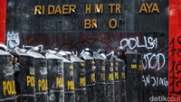 Polisi beratribut lengkap dengan tameng menjaga Markas Brimob Kwitang. 