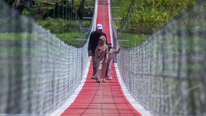 Jembatan Gantung Cicadas Bantu Warga Akses Desa Terisolasi Seorang anak berjalan di atas Jembatan Gantung Sungai Cicadas di Desa Karanganyar, Cililin, Kabupaten Bandung Barat, Jawa Barat, Minggu (31/8/2025). Vertical Rescue Indonesia (VRI) membangun jembatan gantung sepanjang 120 meter yang menghubungkan Desa Karanganyar, Kecamatan Cililin dengan Desa Suka Mulya, Kecamatan Cipongkor guna mempermudah masyarakat yang selama ini kesulitan mengakses layanan pendidikan, ekonomi, kesehatan, hingga administrasi kependudukan akibat kondisi geografis yang terisolasi. ANTARA FOTO/Abdan Syakura/foc.