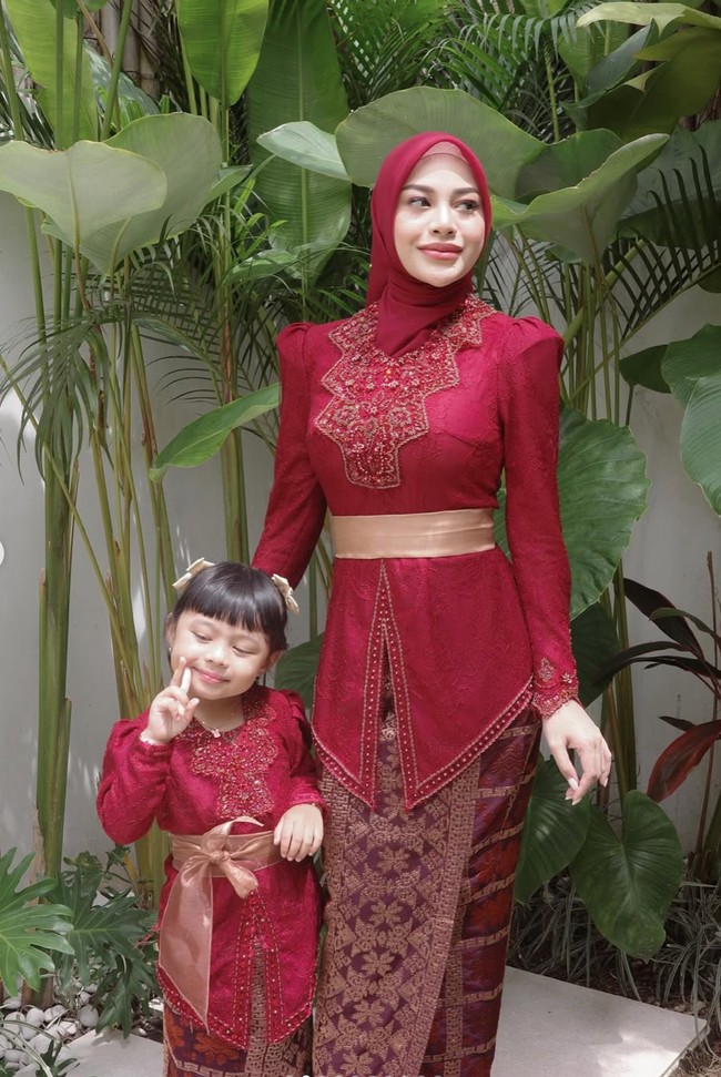 Aurel mengenakan kebaya Bali dengan bahan brokat warna merah marun. Kebaya tersebut memiliki detail bordir mewah di bagian leher hingga dada, memberikan kesan anggun dan elegan. Foto: Instagram/@aurelie.hermansyah