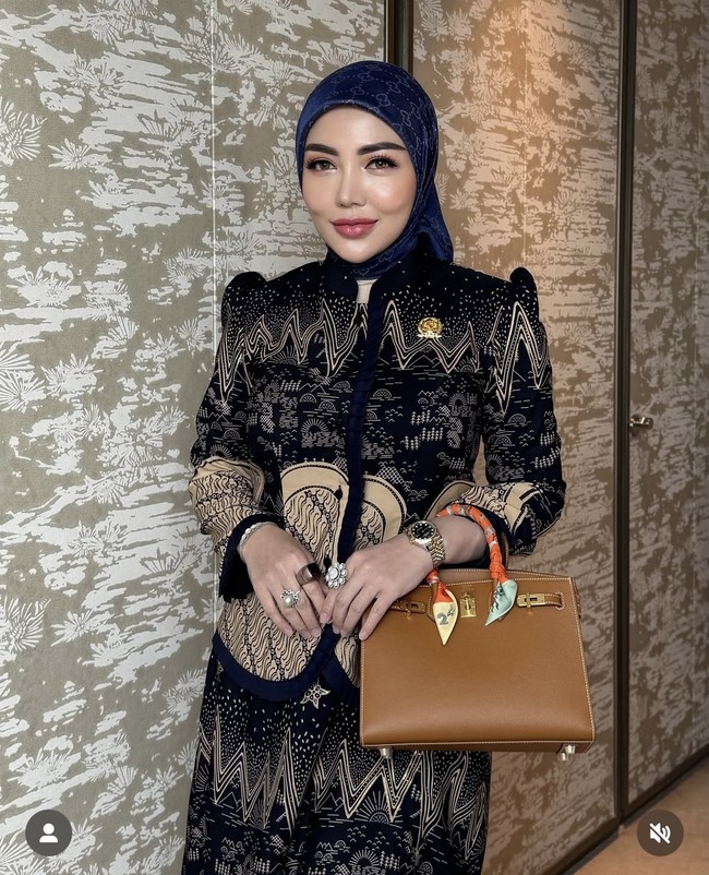 Di lain kesempatan istri pengusaha tambang Daniel Rigan itu juga terlihat mengenakan setelan batik yang elegan berwarna hitam dengan corak coklat. Penampilannya itu dipadukan dengan Hermes Birkin 25 Bag yang harganya capai ratusan juta. Foto: Instagram/@bellashofie_rigan